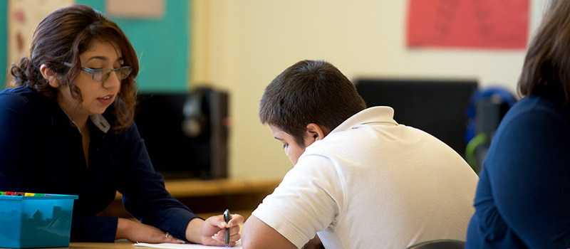 Female talking to child in classroom