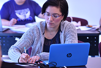 Female student writing in class 