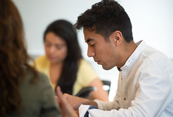 Male writing in class