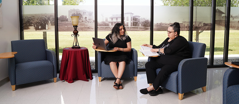 Two students look over papers